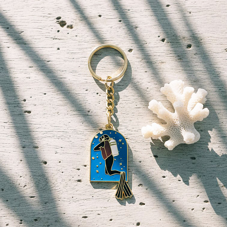 First Breath Underwater Metal Enamel Keychain on Wood